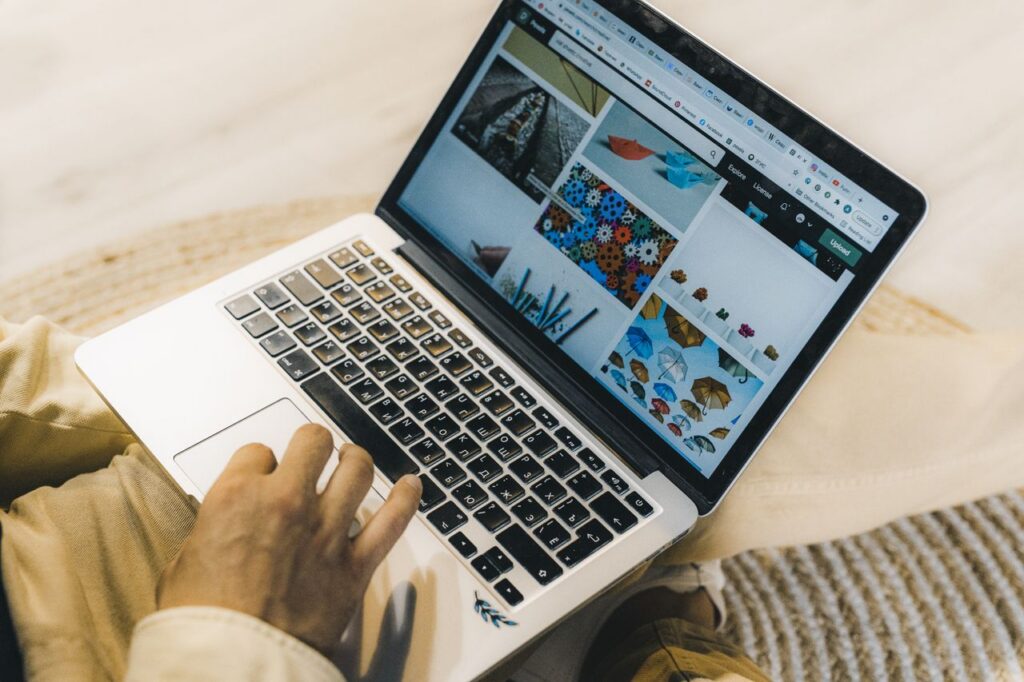 Crafting Captivating Headlines: Your awesome post title goes here A person using a laptop to browse stock photo websites. Freelancing work in a cozy setting.